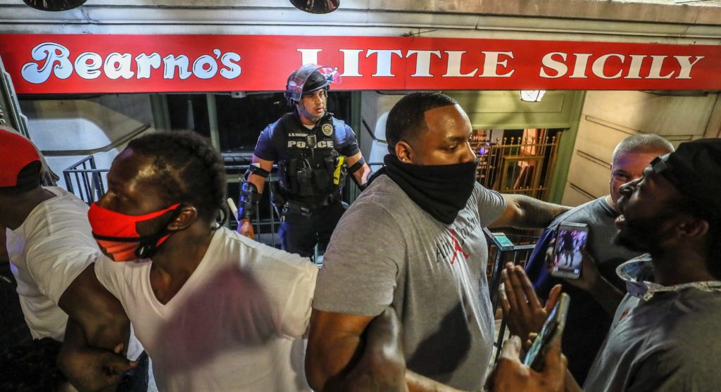 'They saved me': How protesters protected a lone cop, a moment captured in powerful photos