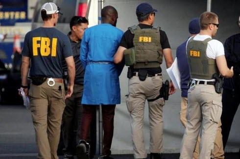FBI agents arrest and charge 80 people in a "massive conspiracy" to defraud millions