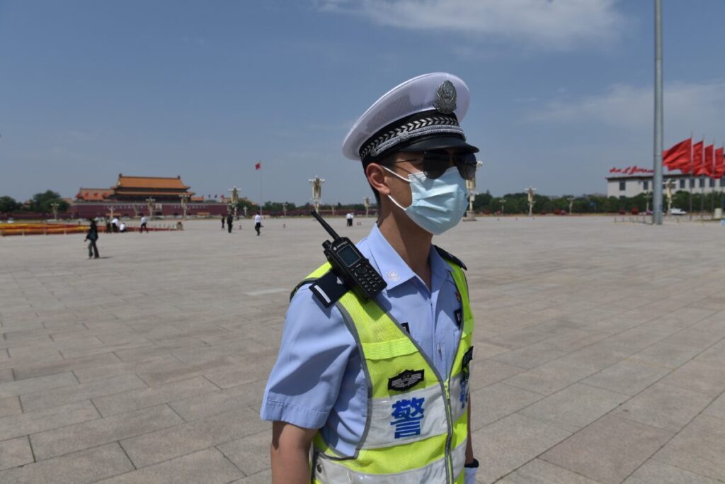 A policeman patrols in Tiananmen Square
