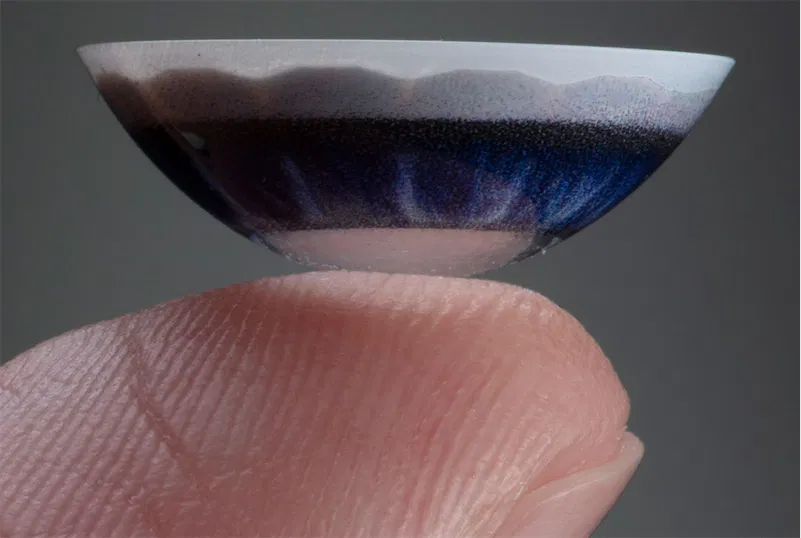 contact lenses on the tip of a finger