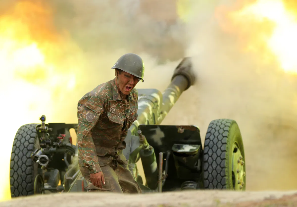 A serviceman of Karabakh's Defense Army fires an artillery piece towards Azeri positions during fighting over the breakaway Nagorno-Karabakh region, September 28, 2020