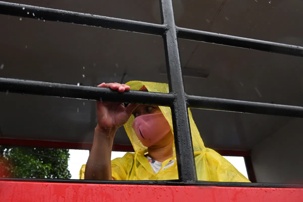 A Filipino resident sits inside a vehicle during an evacuation of informal settlers living along coastal areas in Manila on November 1, 2020, as Super Typhoon Goni moved towards the Philippine capital. Photo: AFP/Ted Aljibe