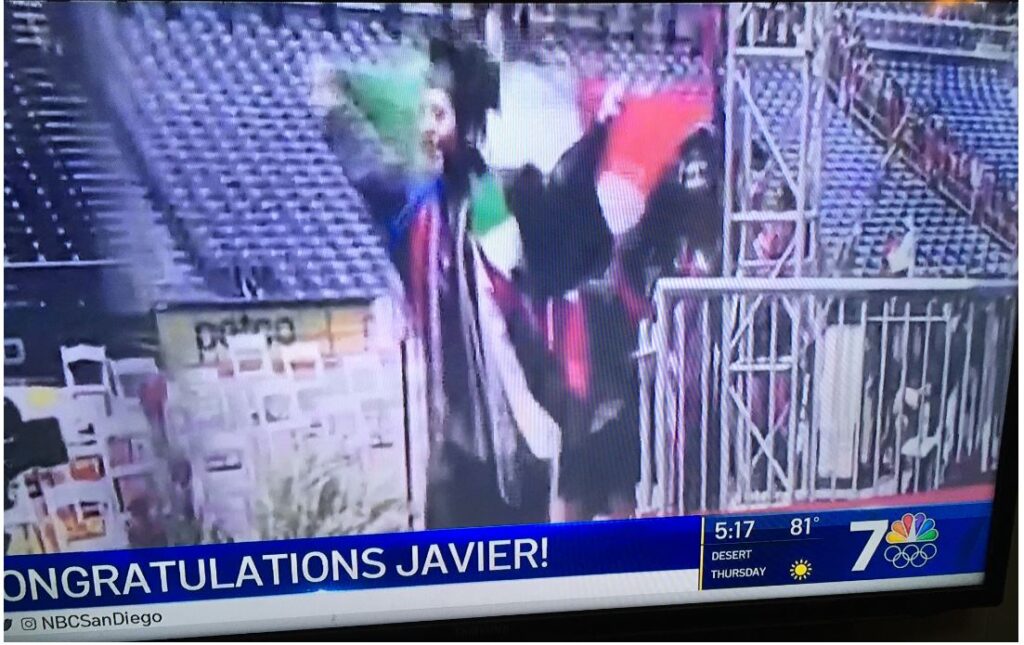 Another illegal graduates, proudly waving the flag of the country he'd do anything not to be sent back to