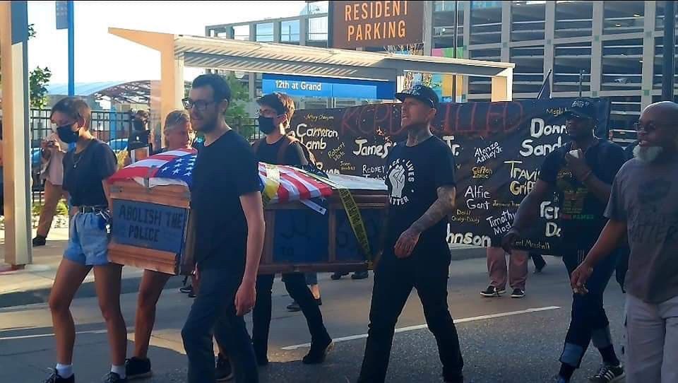 Black Lives Matter Carries Casket of Pig Dressed as a Cop in Kansas City – Rests It at Police Headquarters – In Protest to Abolish Police