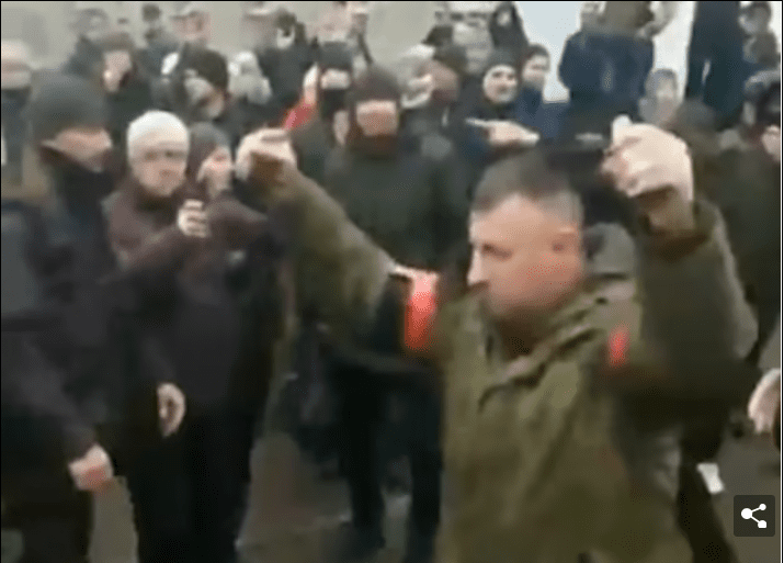 SHOCKING Footage Shows Russian Soldier Holding Two Grenades Above His Head As He Demands Surrender Of Ukrainian Citizens