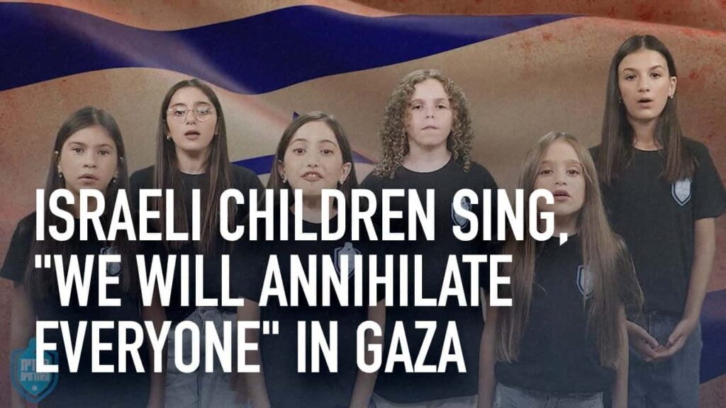Israeli children sing, “We will annihilate everyone” in Gaza, against a background of destruction.