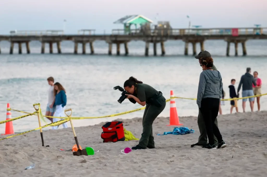Young girl dies after sand hole she was digging with little boy collapses on Florida beach as rescuers try to save them, distressing video shows