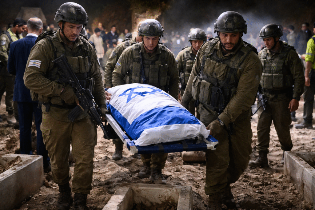 Israeli Defense Forces soldiers carry a flag-draped stretcher during the recovery of Master Sgt. Ran Gvili’s remains in Gaza during Operation Courageous Heart.