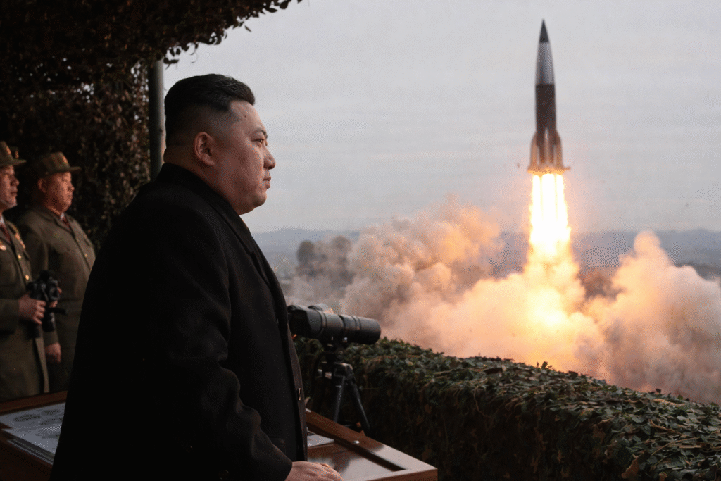 North Korean leader Kim Jong-un observes a hypersonic missile launch from a military observation post as the missile rises with a plume of fire and smoke during a training exercise.