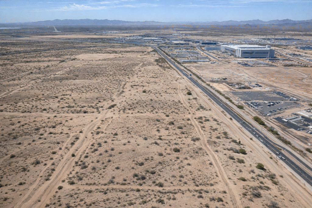 Aerial view of undeveloped Arizona desert land with signs of proposed large-scale development near industrial zones, illustrating the “Qatar City” land proposal.