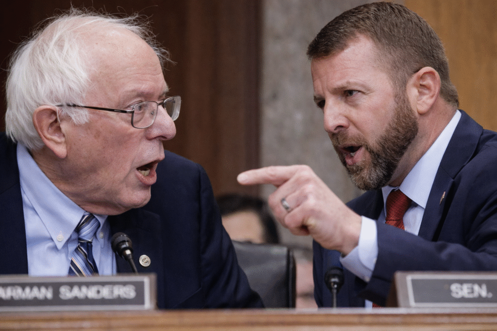 Close-up of Senator Bernie Sanders speaking during a Senate hearing, appearing visibly animated and engaged as healthcare policy is debated.
