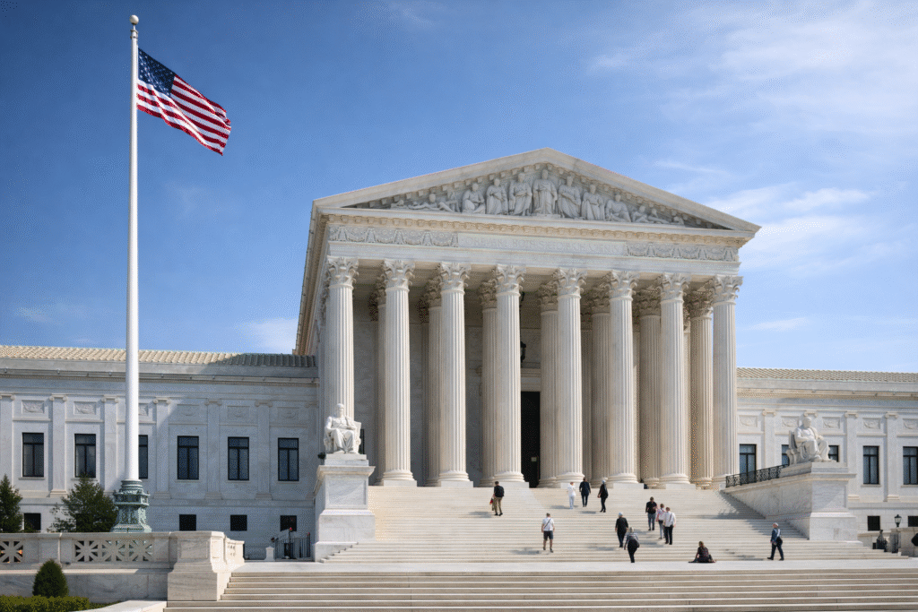 The U.S. Supreme Court building in Washington, D.C., photographed from the front with the American flag flying, representing the high court’s decision on transgender school policy.