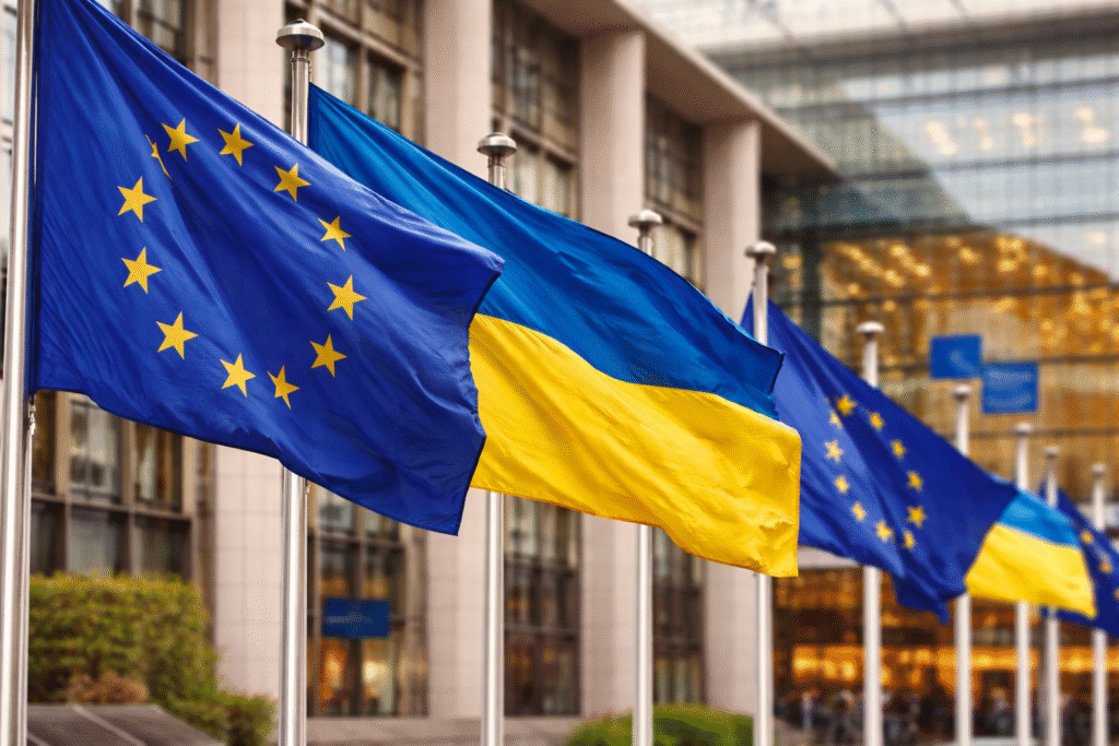 European Union and Ukraine flags displayed outside a government building symbolizing ongoing discussions about EU membership and political integration.