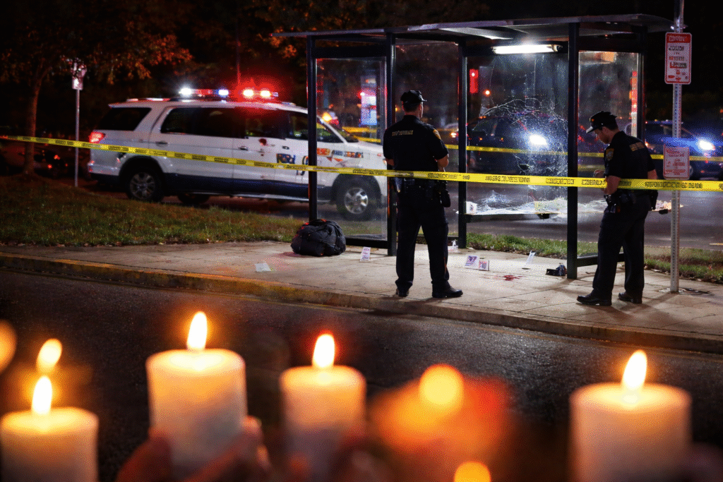 Nighttime police investigation at a bus stop crime scene with officers, police tape, patrol vehicles with flashing lights, and candles placed in the foreground as a memorial.