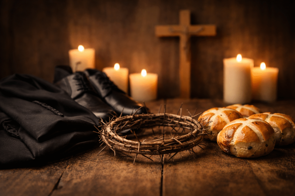 Candlelit church scene with a wooden cross, hot cross buns on a rustic table, and dark clothing symbolizing Good Friday mourning traditions.