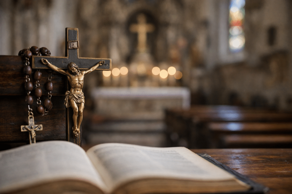 Close-up of a crucifix and rosary resting on an open Bible inside a softly lit Catholic church with blurred altar in the background.