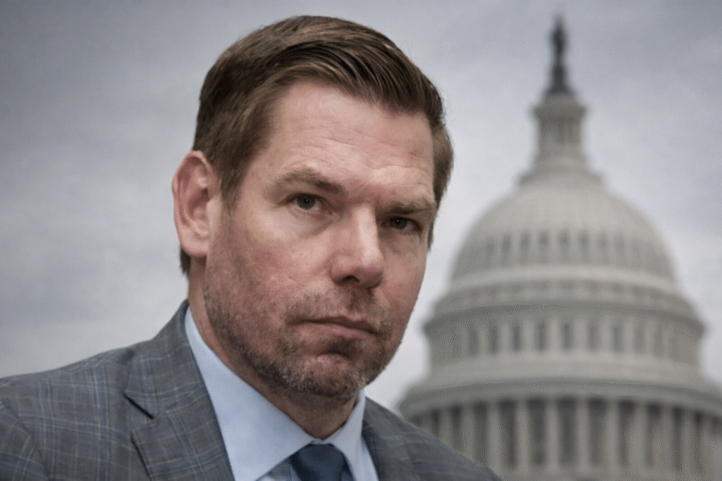Close-up of a man in a gray suit with a serious expression, set against a blurred U.S. Capitol background.