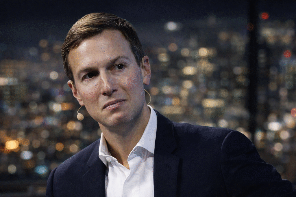 Businessman in a suit wearing a headset microphone, looking to the side against a blurred nighttime city skyline background.