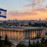 Government buildings in Jerusalem with an Israeli flag in view, symbolizing legal and political proceedings involving national leadership.