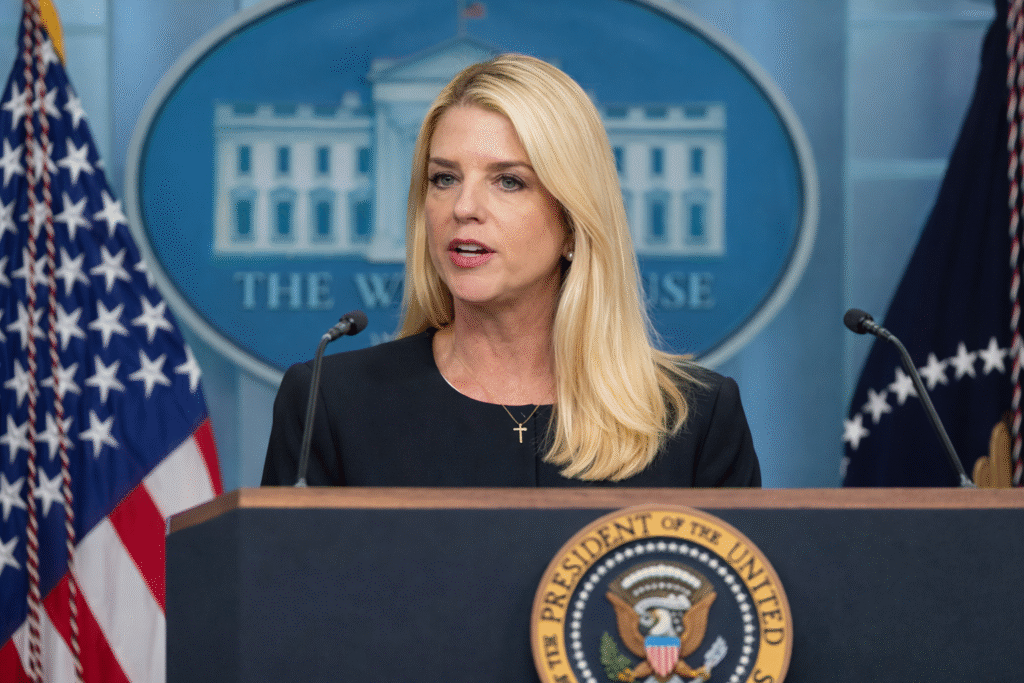Professional woman at a press podium in a government setting delivering a serious public statement.