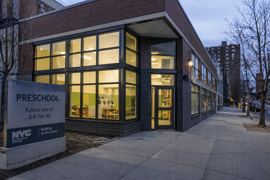 Empty preschool building in an urban setting with lights on but no people, representing unused public facilities and taxpayer-funded waste.