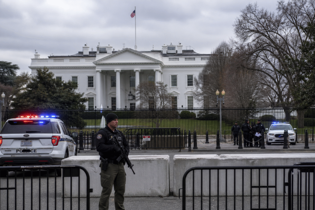 White House exterior with security personnel and barricades during a lockdown situation in Washington DC