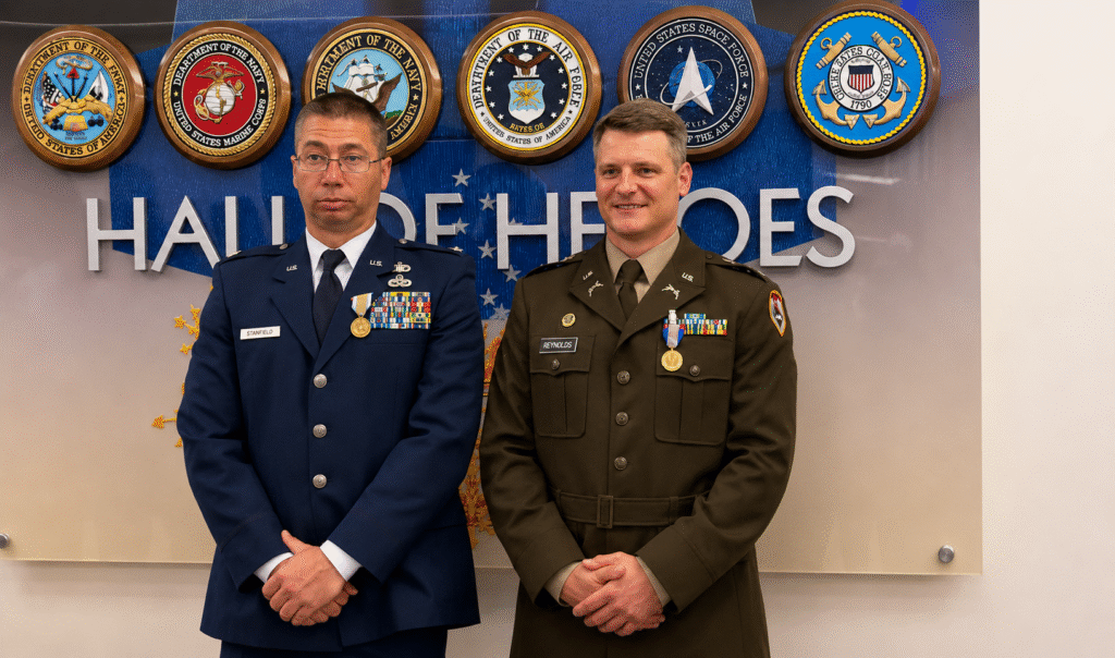 Two decorated West Virginia National Guard officers stand in uniform inside the Pentagon Hall of Heroes after receiving medals for heroism during a deadly attack in Washington, D.C.